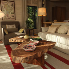 Coffee table made of solid wooden wheel. Cozy decorated living room.