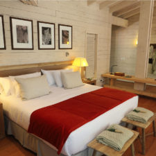 View of the room with a double bed. Rustic architecture in native wood.