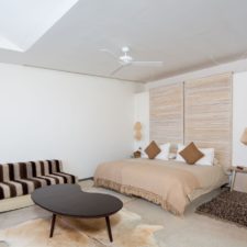 Interior view of room with double bed, large space with skylight that illuminates the place.