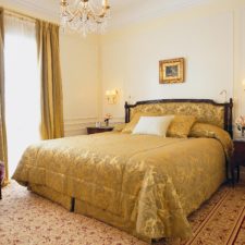 Interior view of hotel room with double bed. Fine fabrics and beautiful classic details.