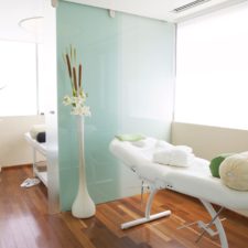 Spa salon with massage tables, brightly lit room, simple and neat.