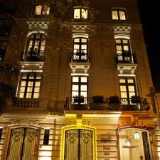 Front view of Boutique Hotel at night. Classical and elegant facade of a five-story building.