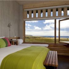 Interior view of room with large double bed. Beautiful view of the surroundings and the sea.
