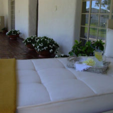 Terrace view with beautiful stone floor, Cozy deck chair, perfect for a rest and a snack.