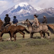 Guazos on horseback in the meadows overlooking the torres del paine.