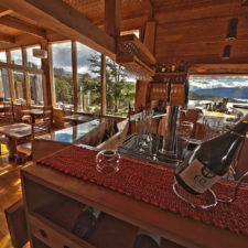Interior view of the Restaurant and bar with beautiful wooden architecture and panoramic view of the Torres del Paine.