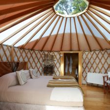 Circular architecture room with skylight above the double bed.