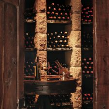 Beautiful rustic doors in native woods with a direct view of the beautiful wine cellar.